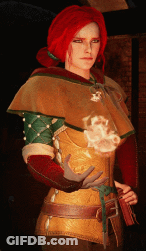 A Woman With Red Hair Is Wearing A Hooded Cape GIF