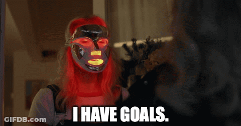 A Woman With Red Hair Is Wearing A Mask And Says I Have Goals GIF