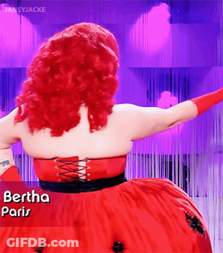 A Woman With Red Hair Is Wearing A Red Dress That Says " Paris " GIF