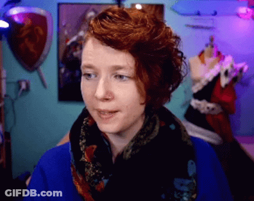 Red Haired Woman Wearing Scarf And Blue Sweater GIF