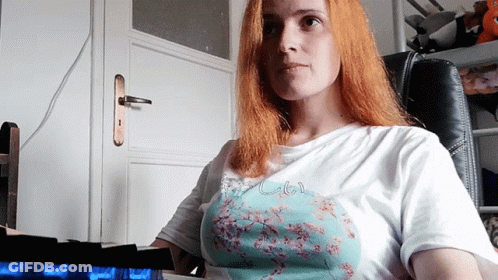 A Woman With Red Hair Is Wearing A T-Shirt That Says " I Love You " GIF