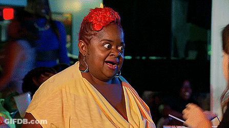 A Woman With Red Hair Is Wearing A Yellow Shirt GIF