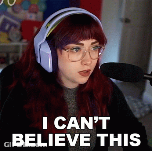 A Woman With Red Hair Is Wearing Headphones And Glasses And Says I Can 'T Believe This GIF