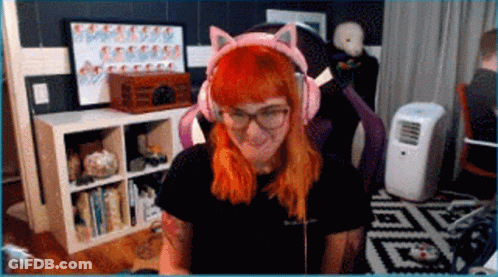 A Woman With Red Hair Is Wearing Pink Cat Ears Headphones GIF