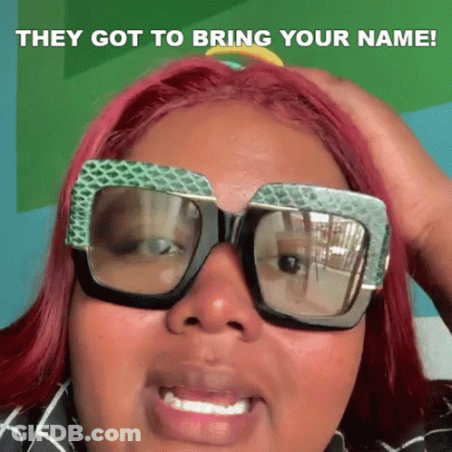 A Woman With Red Hair Is Wearing Sunglasses And Holding Her Hand To Her Head . GIF