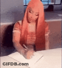 A Woman With Red Hair Is Writing On A Piece Of Paper . GIF