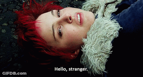 A Woman With Red Hair Laying On The Ground With The Words Hello Stranger Below Her GIF