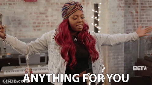 A Woman With Red Hair Says Anything For You In Front Of A Keyboard GIF