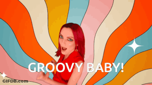 A Woman With Red Hair Says Groovy Baby In Front Of A Psychedelic Background GIF