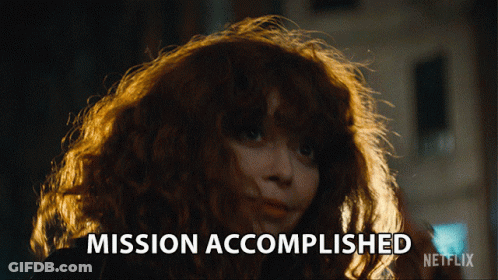 A Woman With Red Hair Says Mission Accomplished On A Netflix Ad GIF