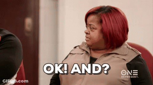 A Woman With Red Hair Says Ok And On A Screen GIF