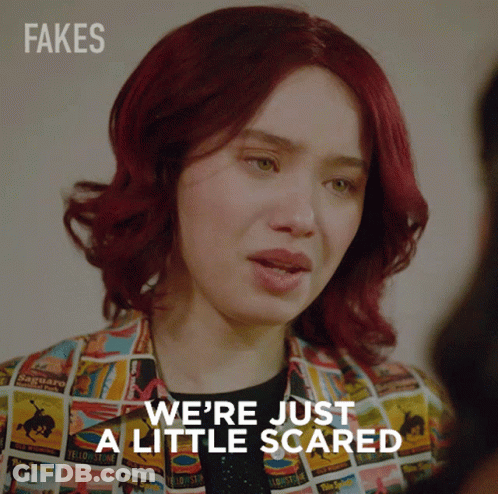 A Woman With Red Hair Says " We 'Re Just A Little Scared " While Wearing A Colorful Jacket GIF