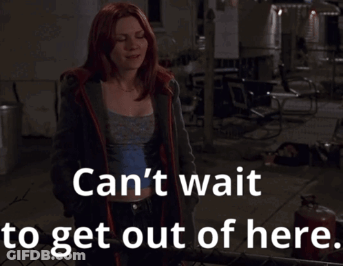 A Woman With Red Hair Stands In Front Of A Fence With The Words Can 'T Wait To Get Out Of Here GIF