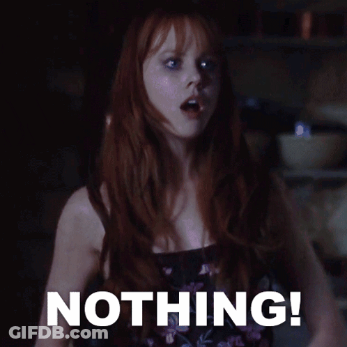 A Woman With Red Hair Stands In Front Of A Sign That Says " Nothing " GIF