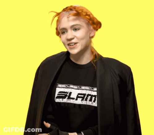 A Woman With Red Hair Wearing A Black Shirt That Says Slam GIF