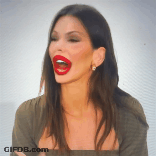 A Woman With Red Lips Is Making A Funny Face With Her Mouth Open GIF