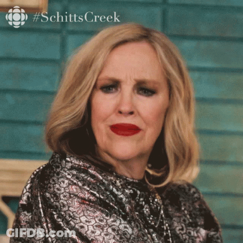 A Woman With Red Lipstick And A #Schitts Creek Logo GIF