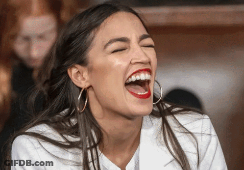 A Woman With Red Lipstick And Hoop Earrings Is Laughing With Her Eyes Closed GIF