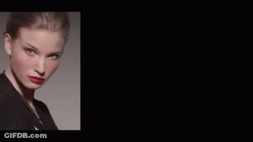 A Woman With Red Lipstick And Purple Lipstick On Her Lips Is Wearing A Black Jacket . GIF