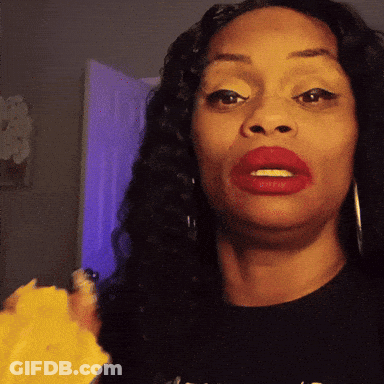 A Woman With Red Lipstick Is Wearing A Black Shirt That Says ' A ' On The Front GIF