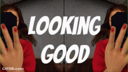 A Woman With Red Nail Polish Is Holding A Black Box And The Words Looking Good Are Behind Her GIF
