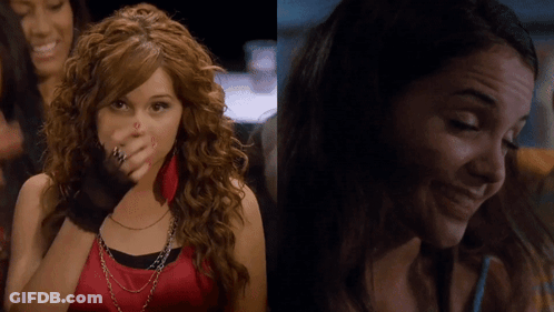 A Woman With Red Nails Is Covering Her Face With Her Hand And Another Woman Is Smiling GIF