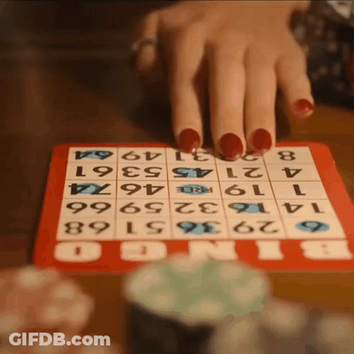 A Woman With Red Nails Is Playing Bingo With A Red Board GIF