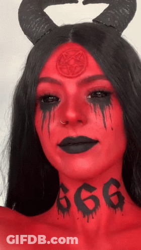 A Woman With Red Paint On Her Face Has The Number 666 Tattooed On Her Neck GIF