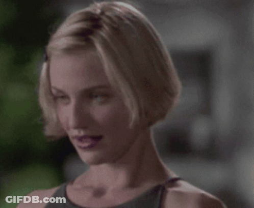 A Woman With Short Blonde Hair And Purple Lips GIF