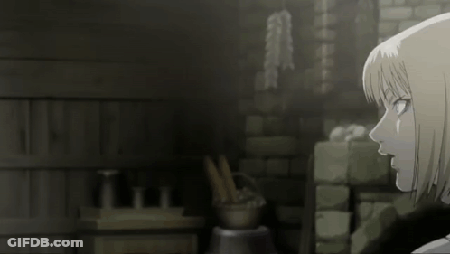A Woman With Short Blonde Hair Is Standing In Front Of A Brick Wall GIF