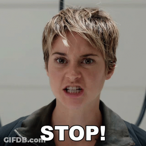 A Woman With Short Hair Is Making A Funny Face And The Word Stop Is Above Her Face GIF