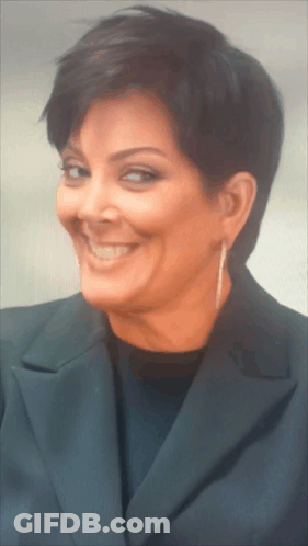 A Woman With Short Hair Is Smiling For The Camera GIF