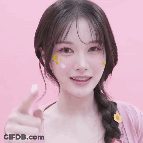 A Woman With Stickers On Her Face Is Pointing Her Finger GIF