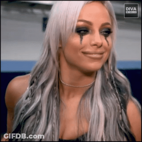 A Woman With Tears Running Down Her Face Is Wearing A Diva Buckle Shirt GIF