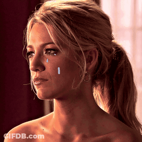 A Woman With Tears Running Down Her Face Is Wearing Earrings GIF