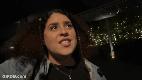 A Woman With The Word Demure On Her Face GIF