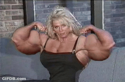 Woman With Large Muscles Sitting On Couch GIF