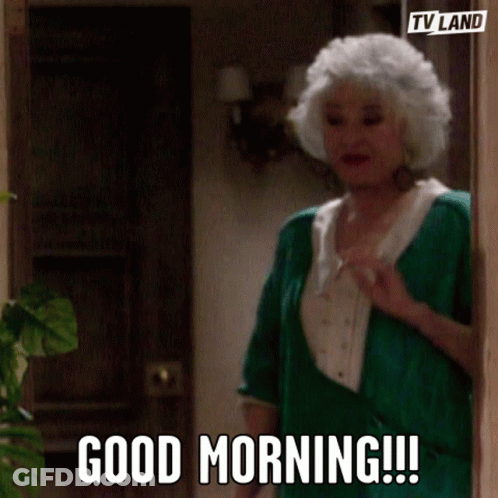 A Woman With White Hair And A Green Shirt Says Good Morning GIF