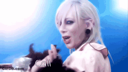 A Woman With White Hair Is Holding A Cat And The Word Call Is On The Screen GIF