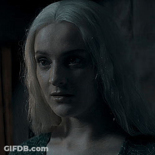 A Woman With White Hair Is Looking At The Camera GIF
