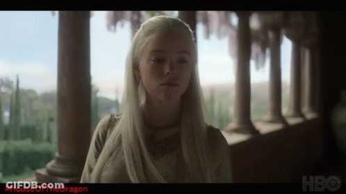 A Woman With White Hair Is Standing In Front Of A Row Of Columns And The Words House Of The Dragon Are On The Bottom GIF