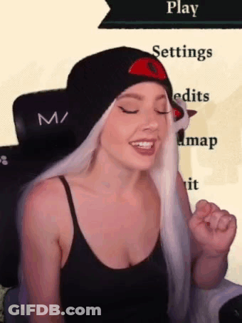 A Woman With White Hair Is Wearing A Black Tank Top And A Black Hat . GIF