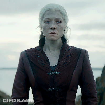 A Woman With White Hair Is Wearing A Burgundy Leather Jacket GIF