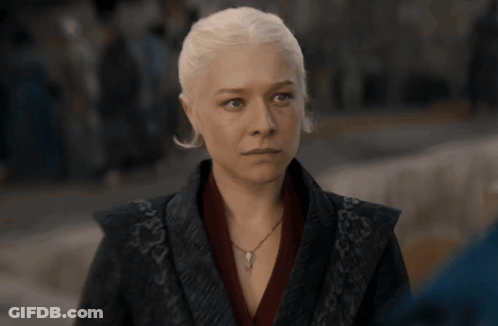 A Woman With White Hair Is Wearing A Necklace And A Black Jacket GIF