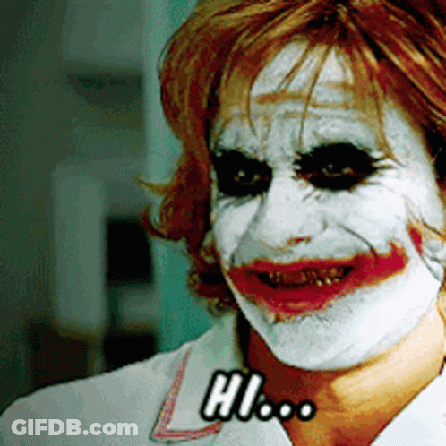 A Woman With White Paint On Her Face And The Word Hi On Her Chest GIF
