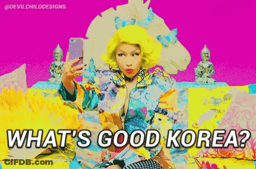 A Woman With Yellow Hair Is Taking A Selfie With The Words What 'S Good Korea Below Her GIF