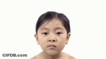 A Woman Without A Shirt Is Looking At The Camera With A Serious Look On Her Face . GIF
