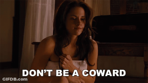 A Woman Wrapped In A Towel With The Words " Don 'T Be A Coward " Below Her GIF