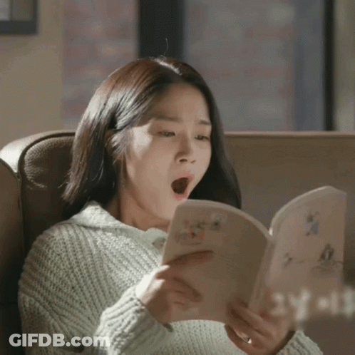A Woman Yawning While Reading A Book That Says Yeah GIF