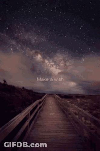 A Wooden Bridge With The Words Make A Wish Written In The Sky GIF
